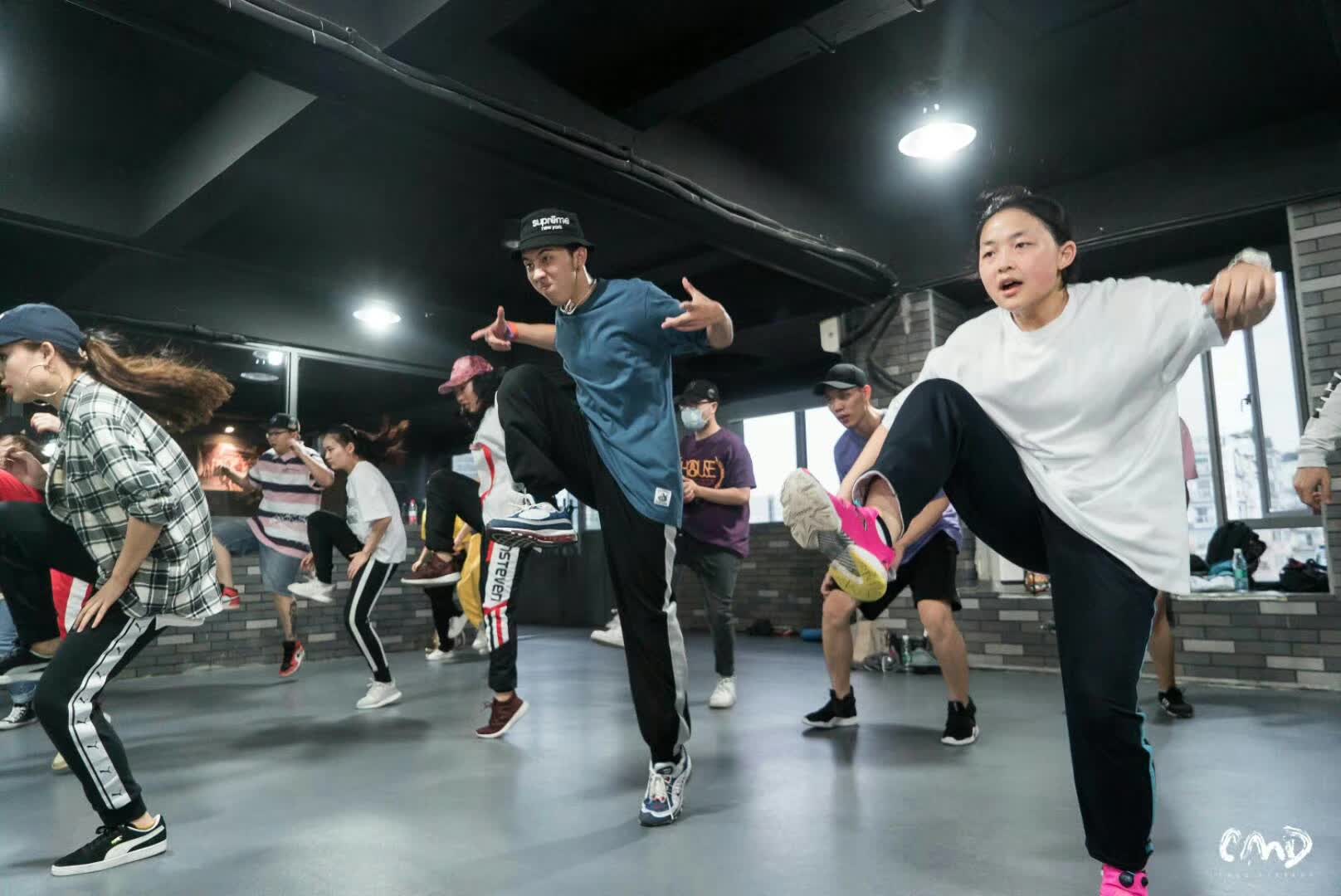 A group practicing dance moves together in a studio.